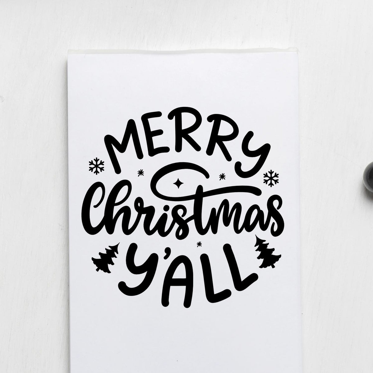 Black Merry Christmas Yall stamp design on white paper with snowflakes and trees, festive holiday seal for cards and gifts