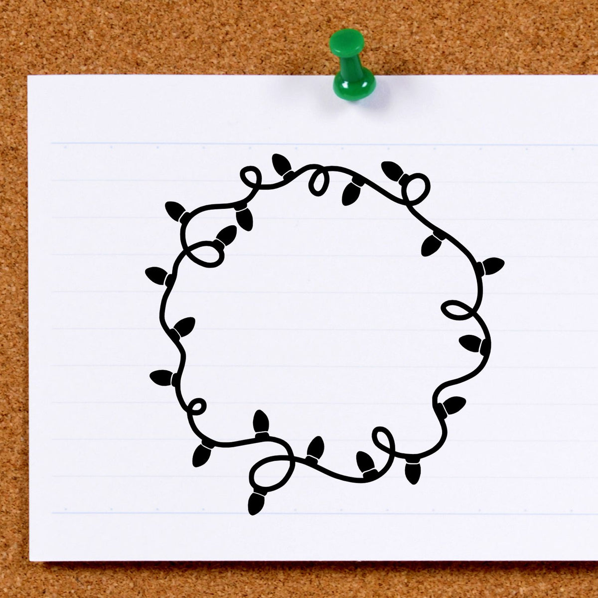 Black string-light stamp and seal design on lined white paper, pinned to corkboard with a green push pin.