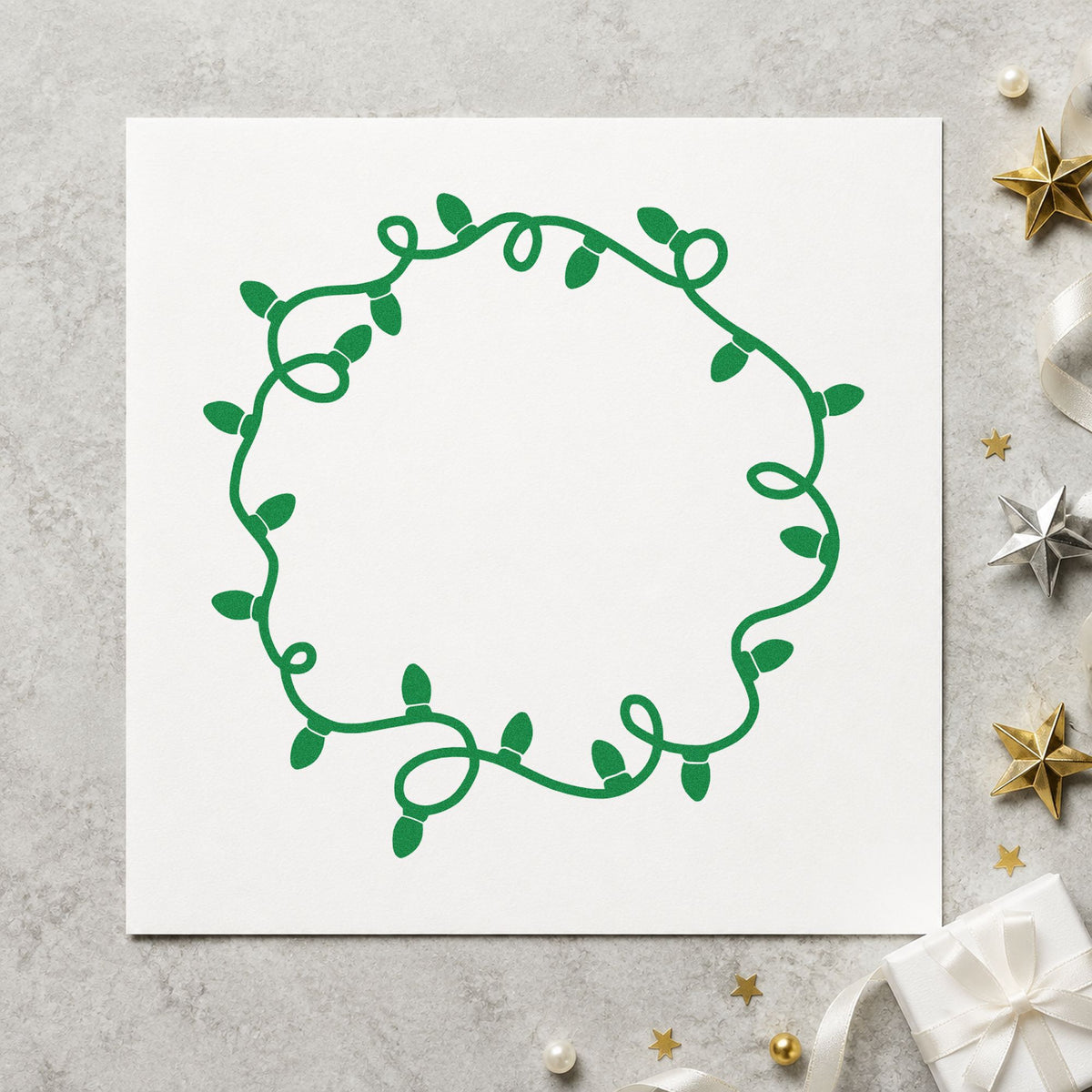 Circular Christmas Light Border craft stamp imprint in green ink on a handmade project, one idea being initial gift tags.