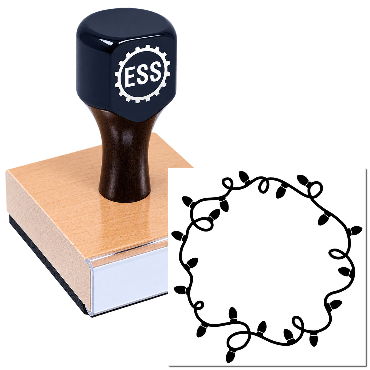 Black ESS rubber stamp on a wooden block beside a white seal design with a black string-light wreath.
