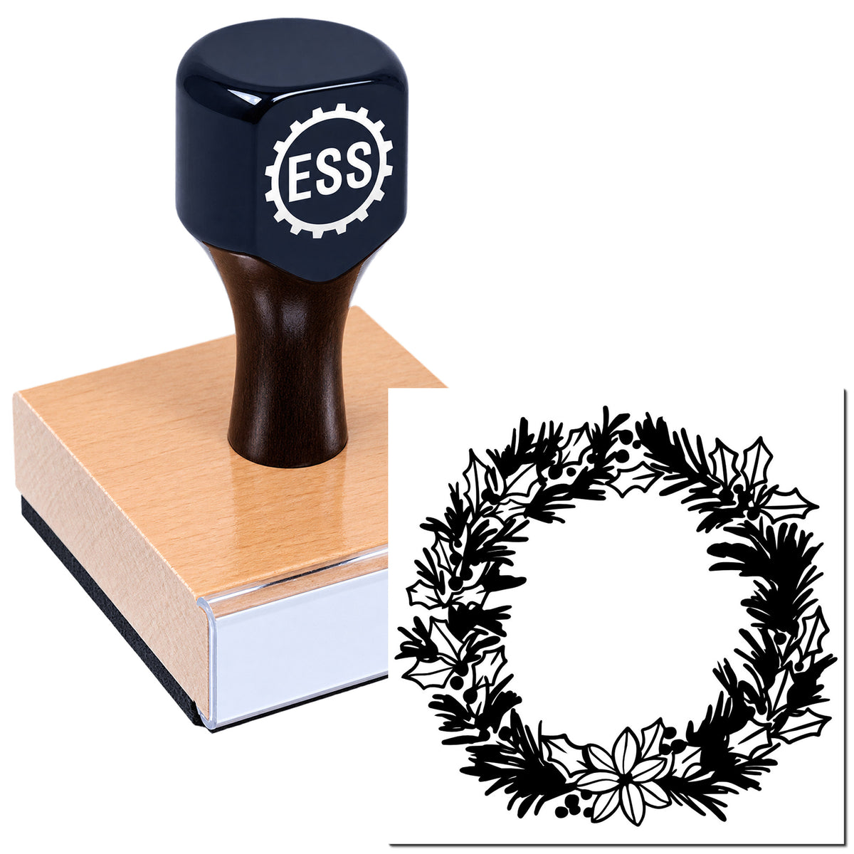 Dark navy ESS rubber stamp on a wooden block, with a black holly wreath seal design