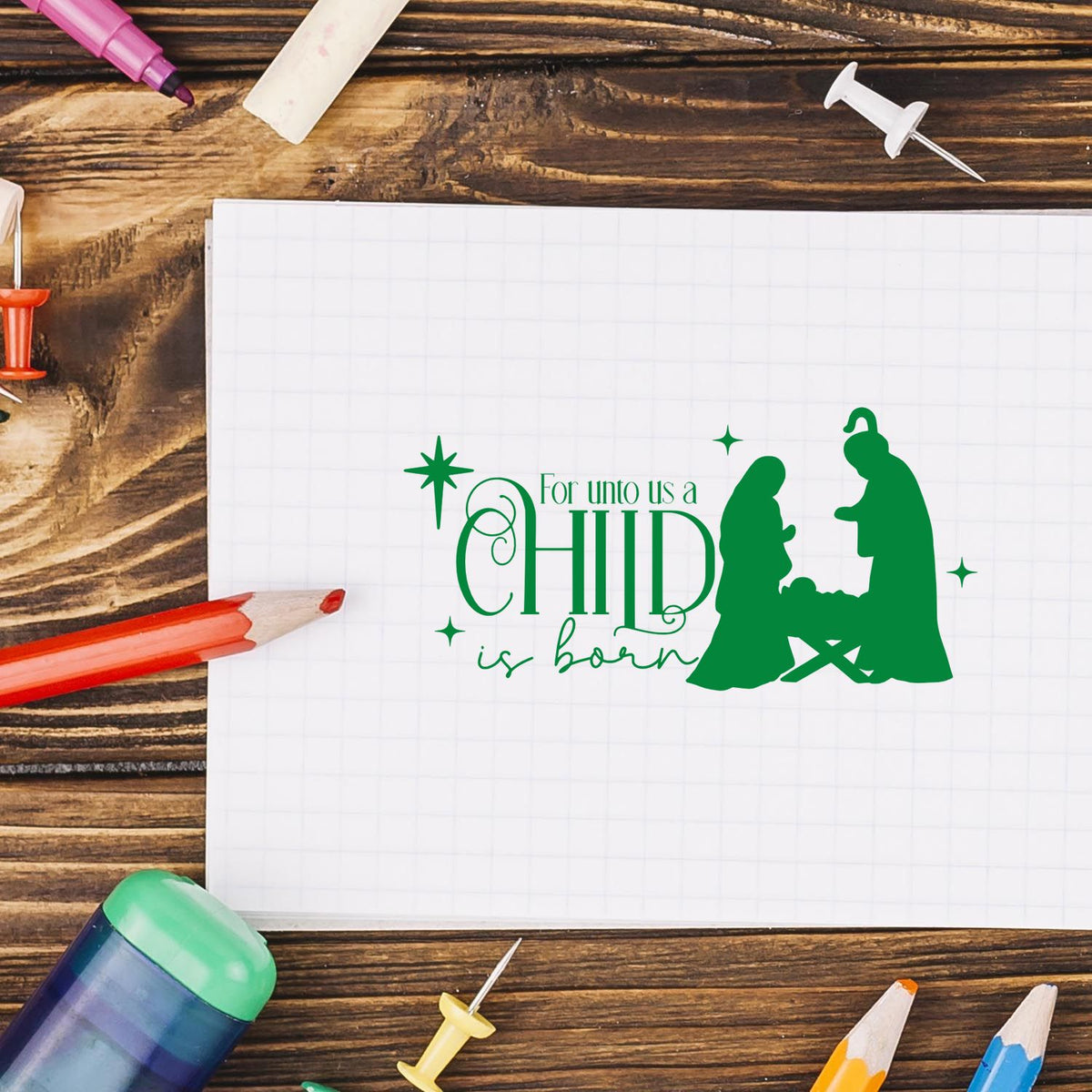 Green holiday stamp/seal design reading For unto us a CHILD is born with nativity silhouettes and stars.