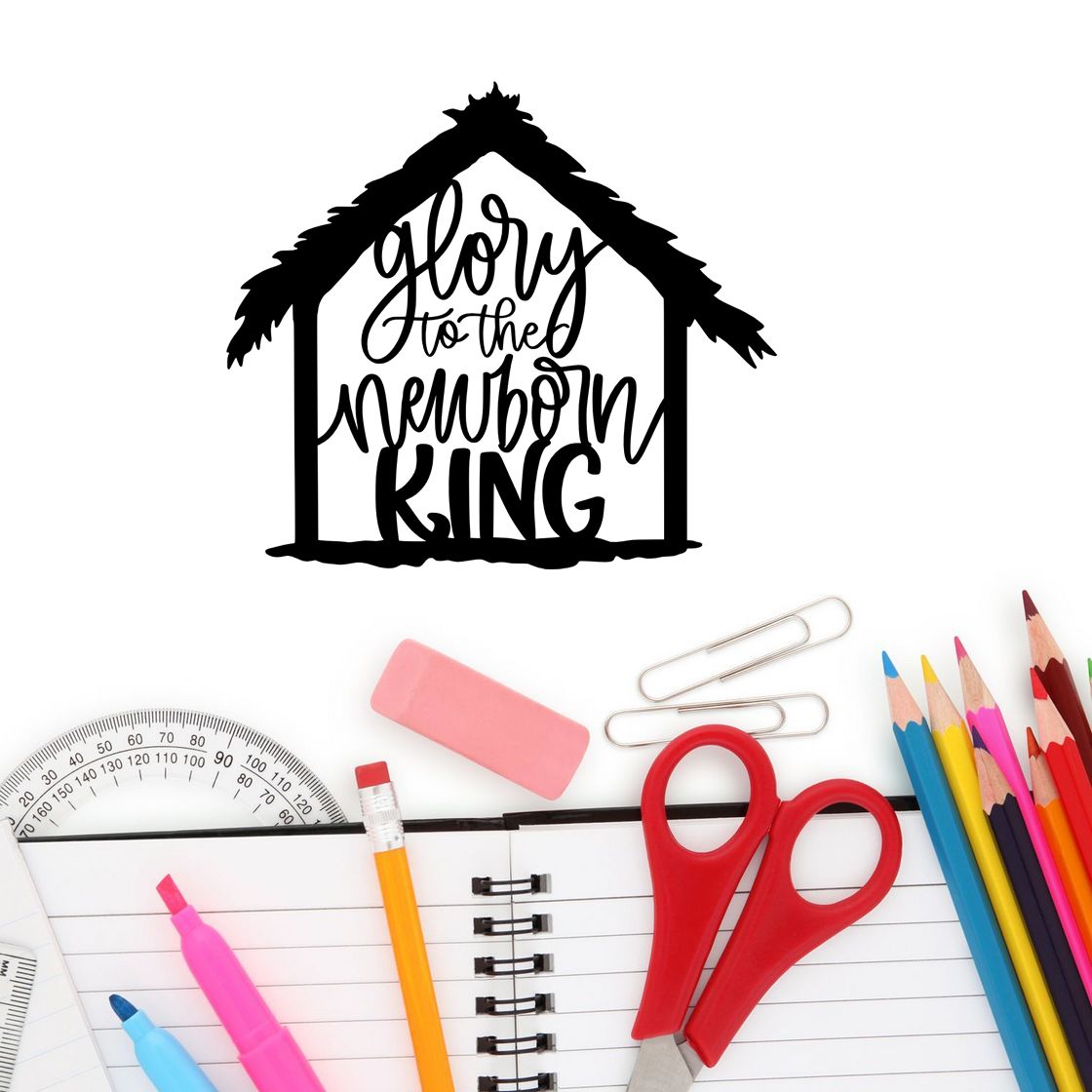 Black house-shaped stamp seal reading glory to the newborn king above school supplies, with red scissors and colorful pencils.