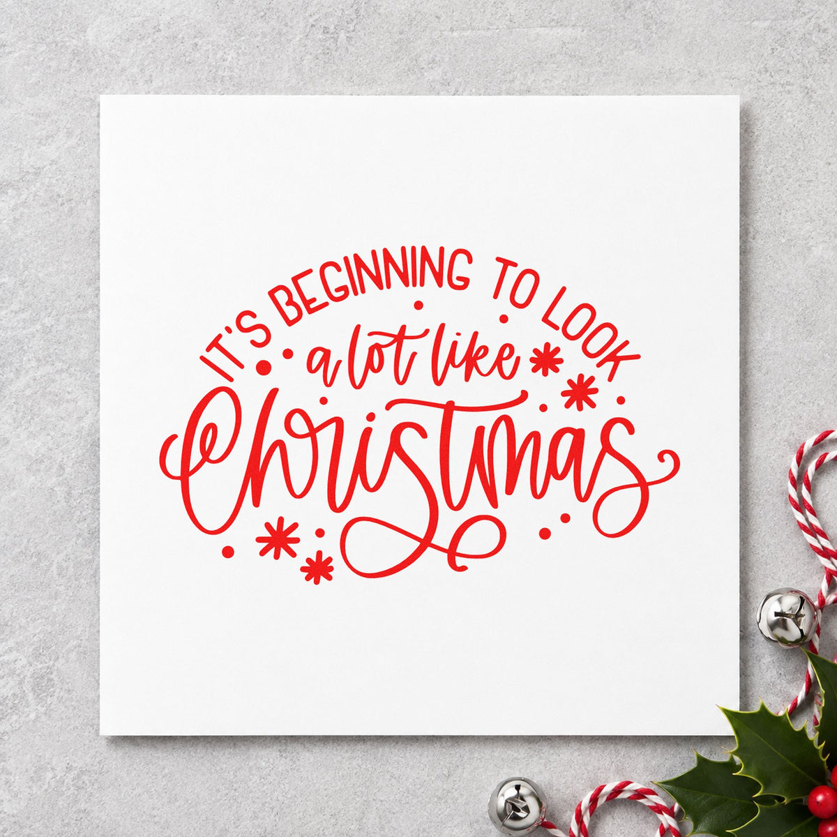 Beginning To Look Like Christmas rubber stamp shown in red ink, stamped for projects such as light reel labels.