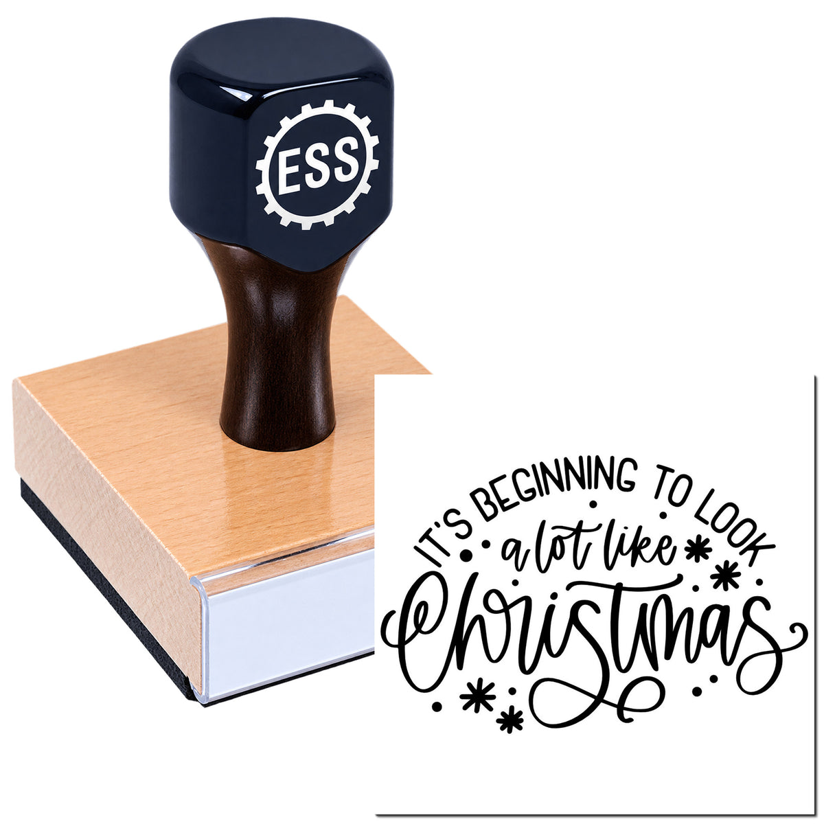 Dark navy ESS rubber stamp with wooden base, showing black "It's beginning to look a lot like Christmas" seal.