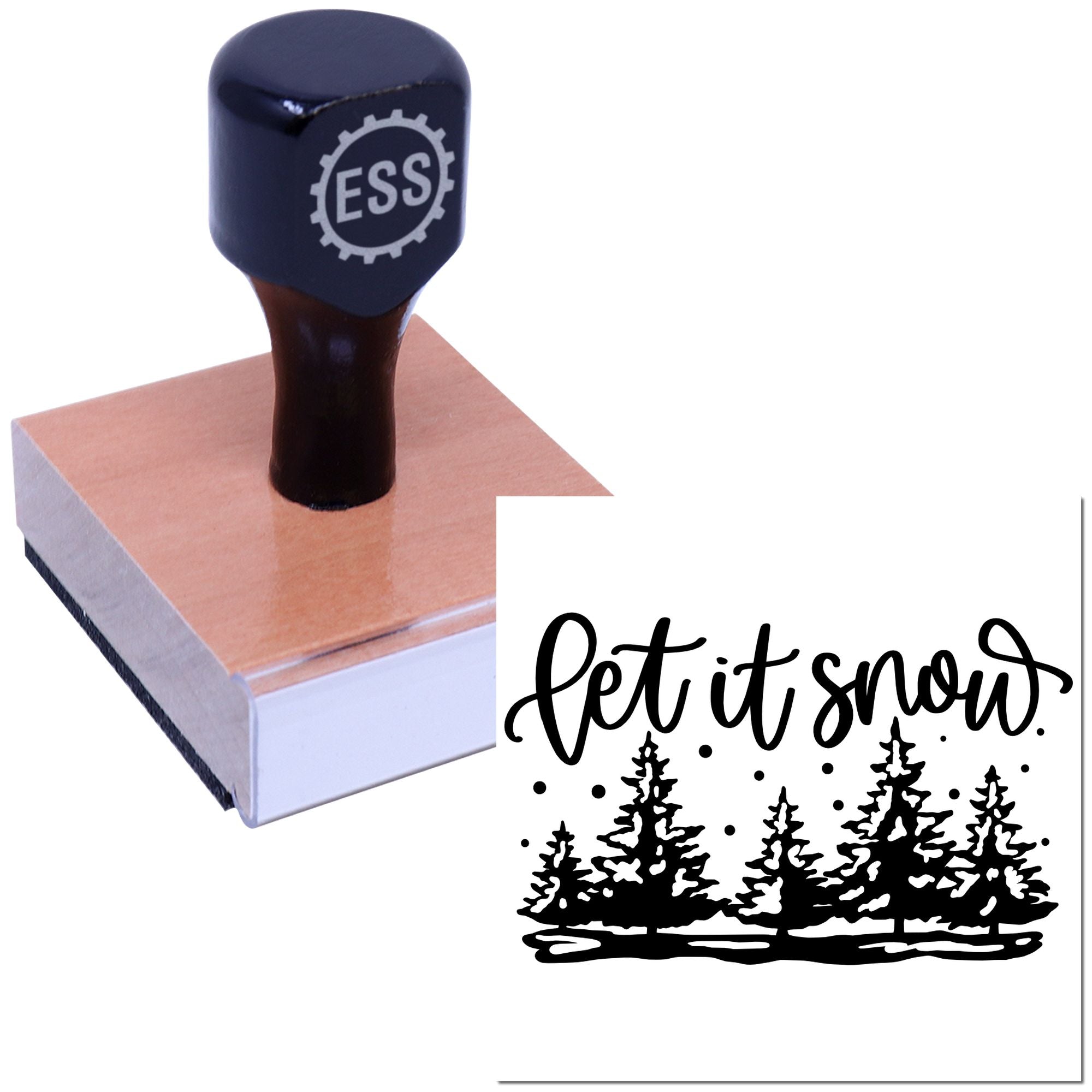 Black ESS rubber stamp on a wooden block, creating a black Let it snow seal with pine trees and snowflakes.