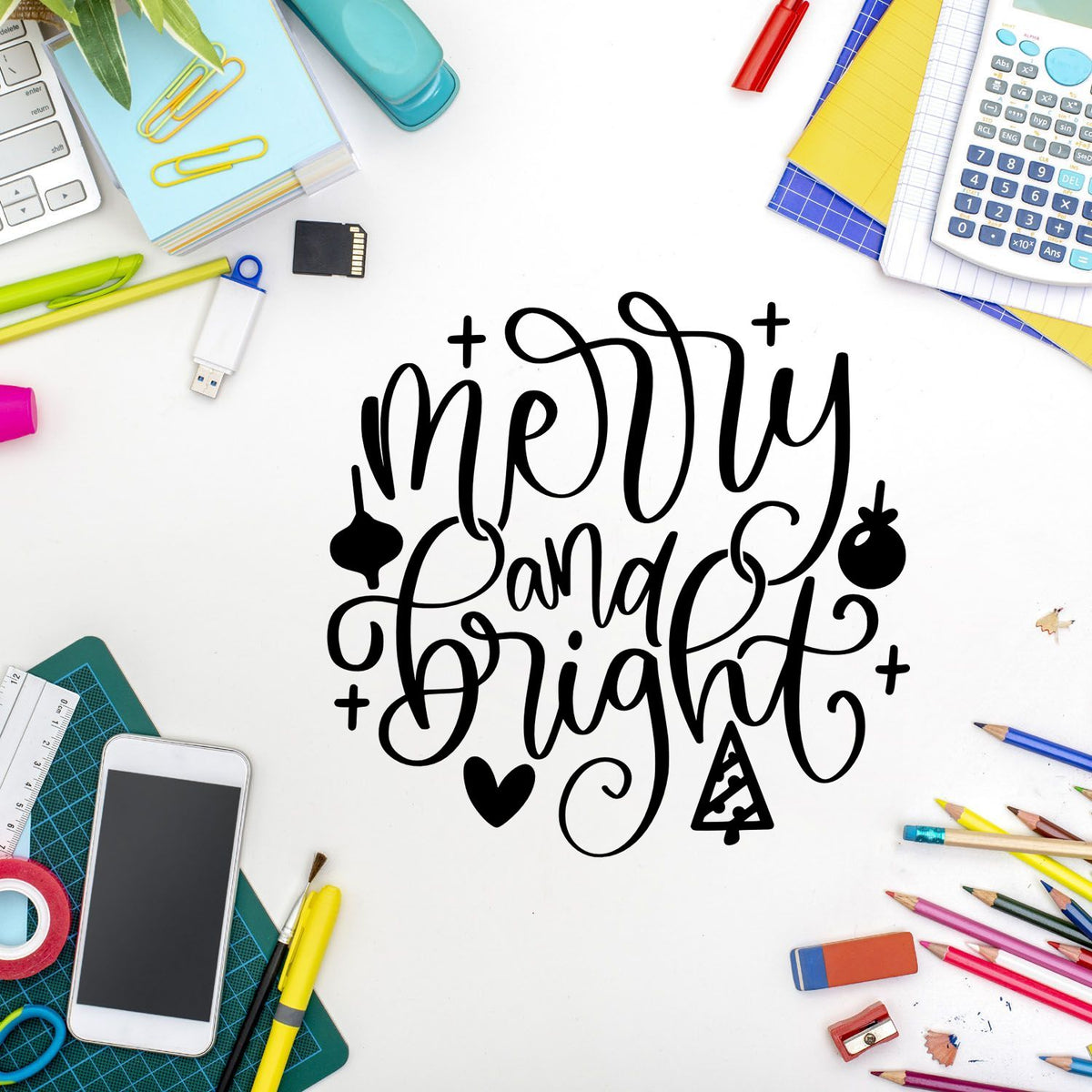 Black Merry and Bright calligraphy with colorful stationery, craft tools, and stamp and seal products on a white desk.