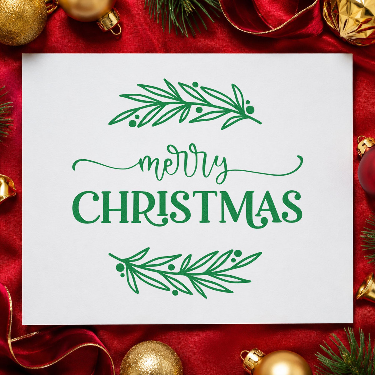 Merry Christmas Between Branches craft stamp imprint in green ink on a handmade project, one idea being strip gift tags.