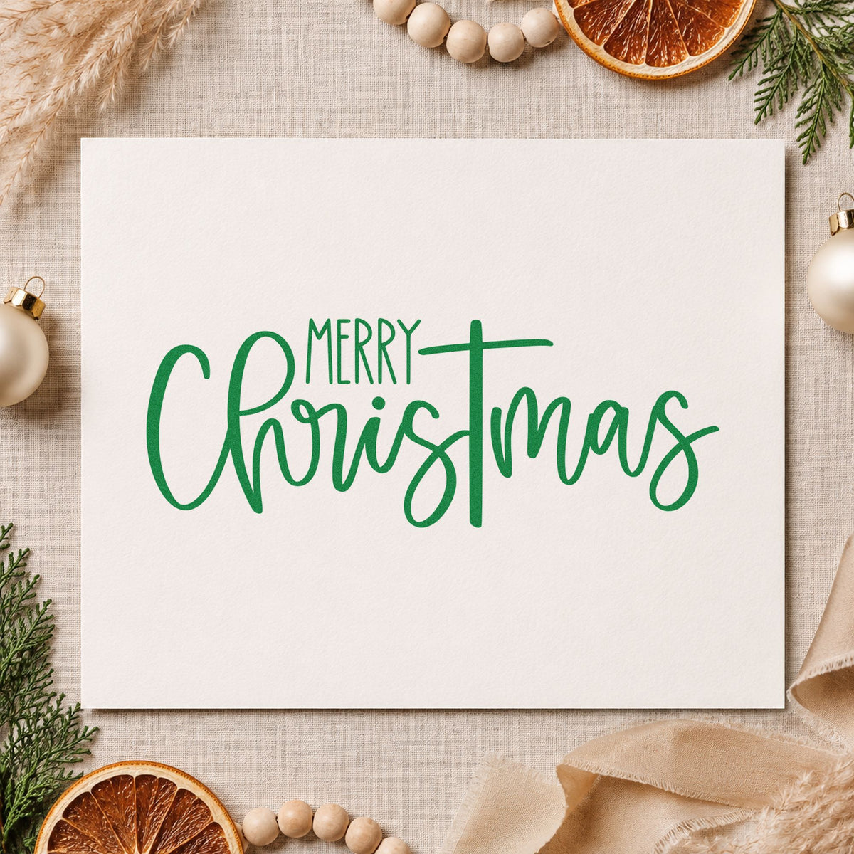 Merry Christmas Narrow Script craft stamp imprint in green ink on a handmade project, one idea being bottle neck wraps.