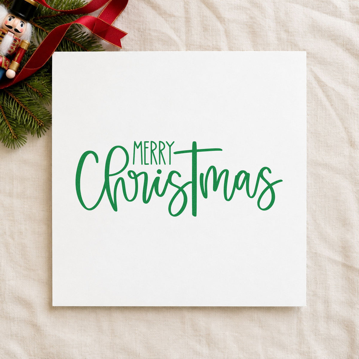 Merry Christmas Narrow Script craft stamp imprinted in green ink on paper, a design suited to framed narrow niche.