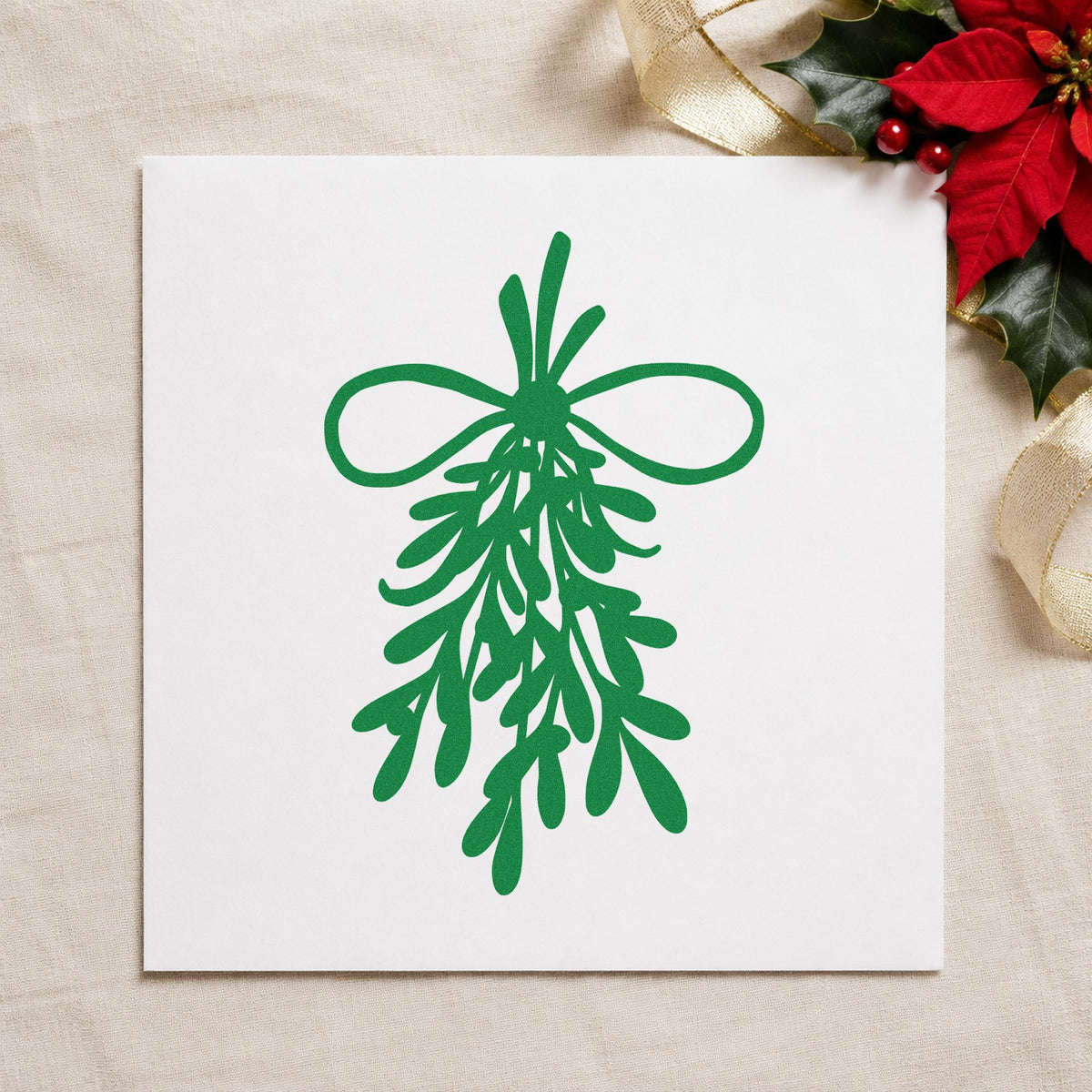 Mistletoe Bundle With Bow craft stamp imprint in green ink on a handmade project, one idea being twine loop tags.