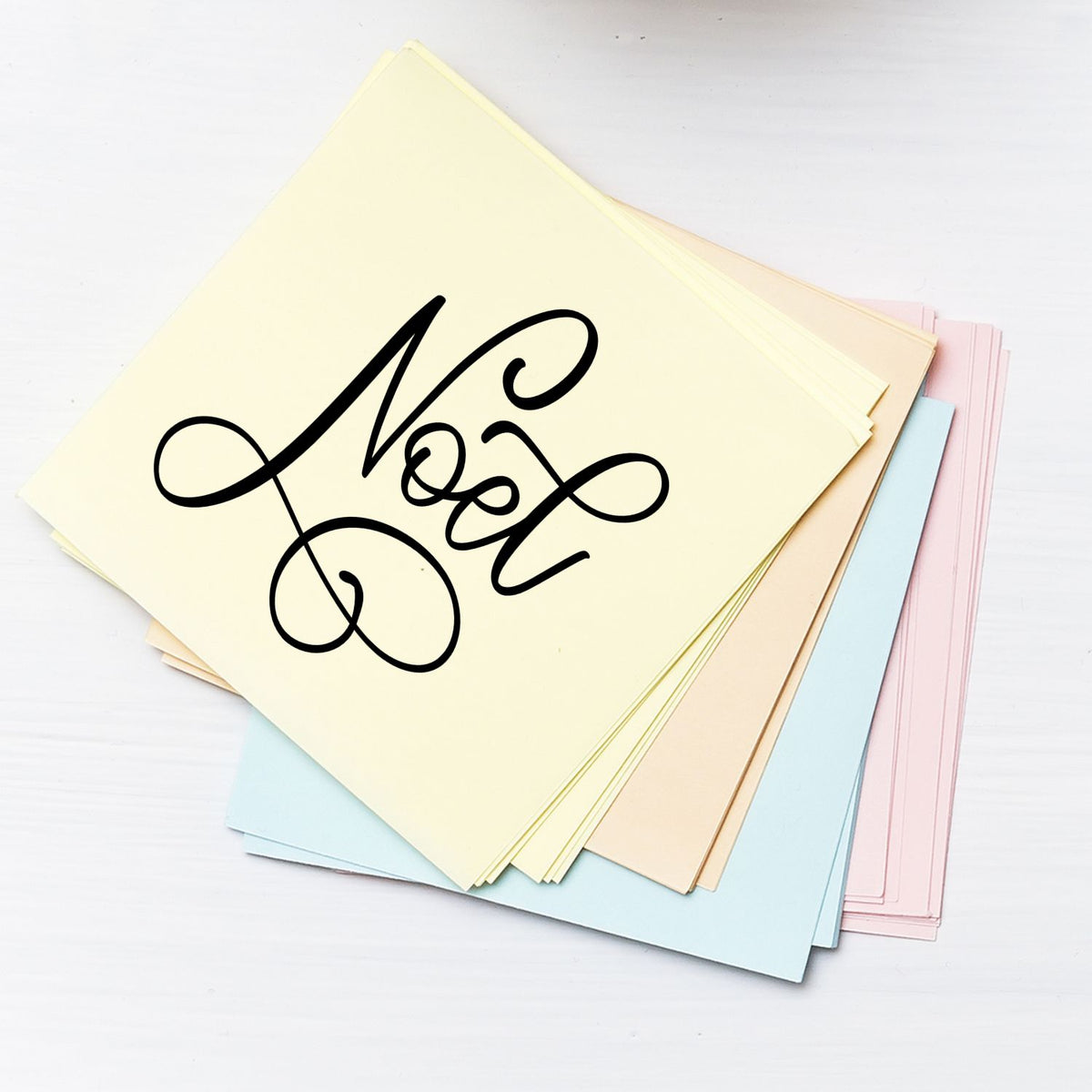 Pastel stamp and seal sheets in cream, blue, pink and peach with bold black calligraphy design