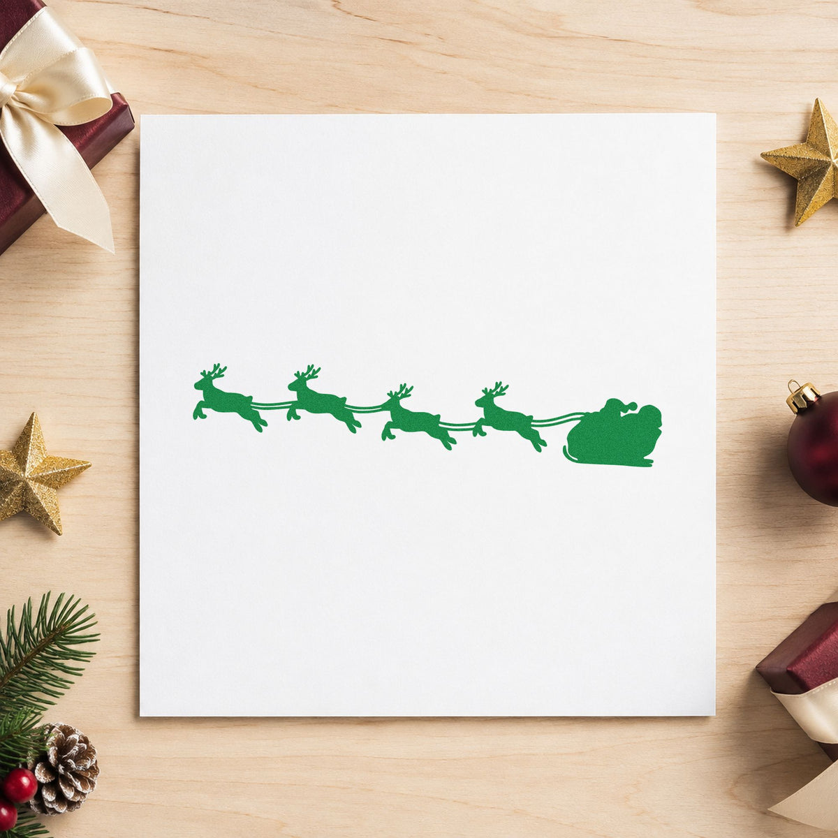 Santa Sleigh Reindeer Silhouette craft stamp imprint in green ink on a handmade project, one idea being long strip gift tags.