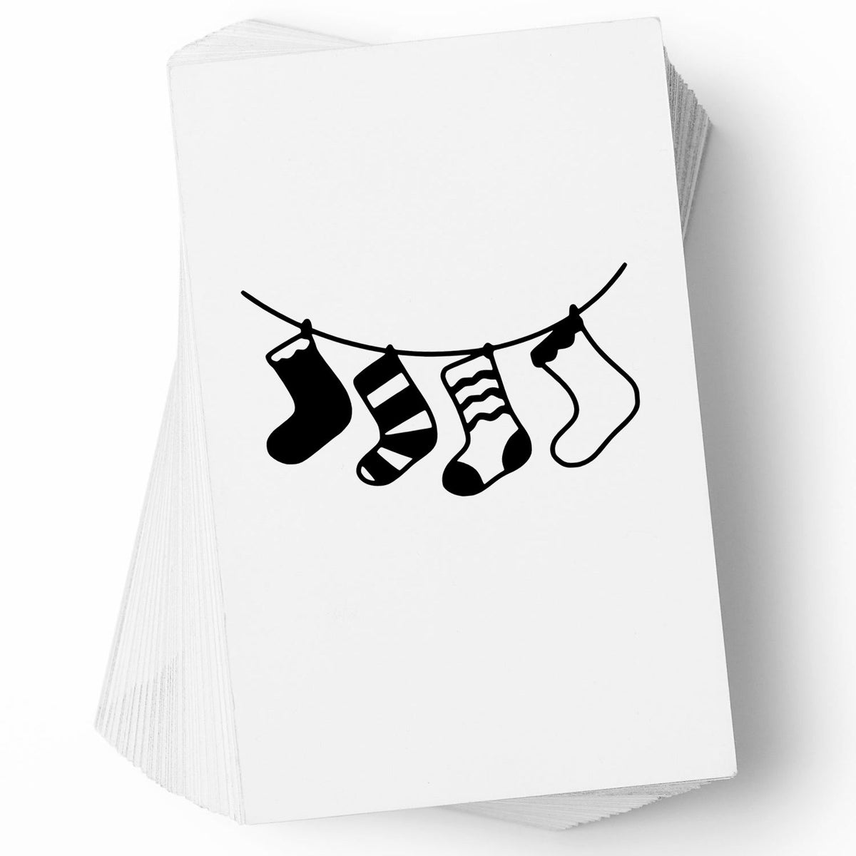 Stack of white stamp and seal cards featuring black hanging Christmas stockings design