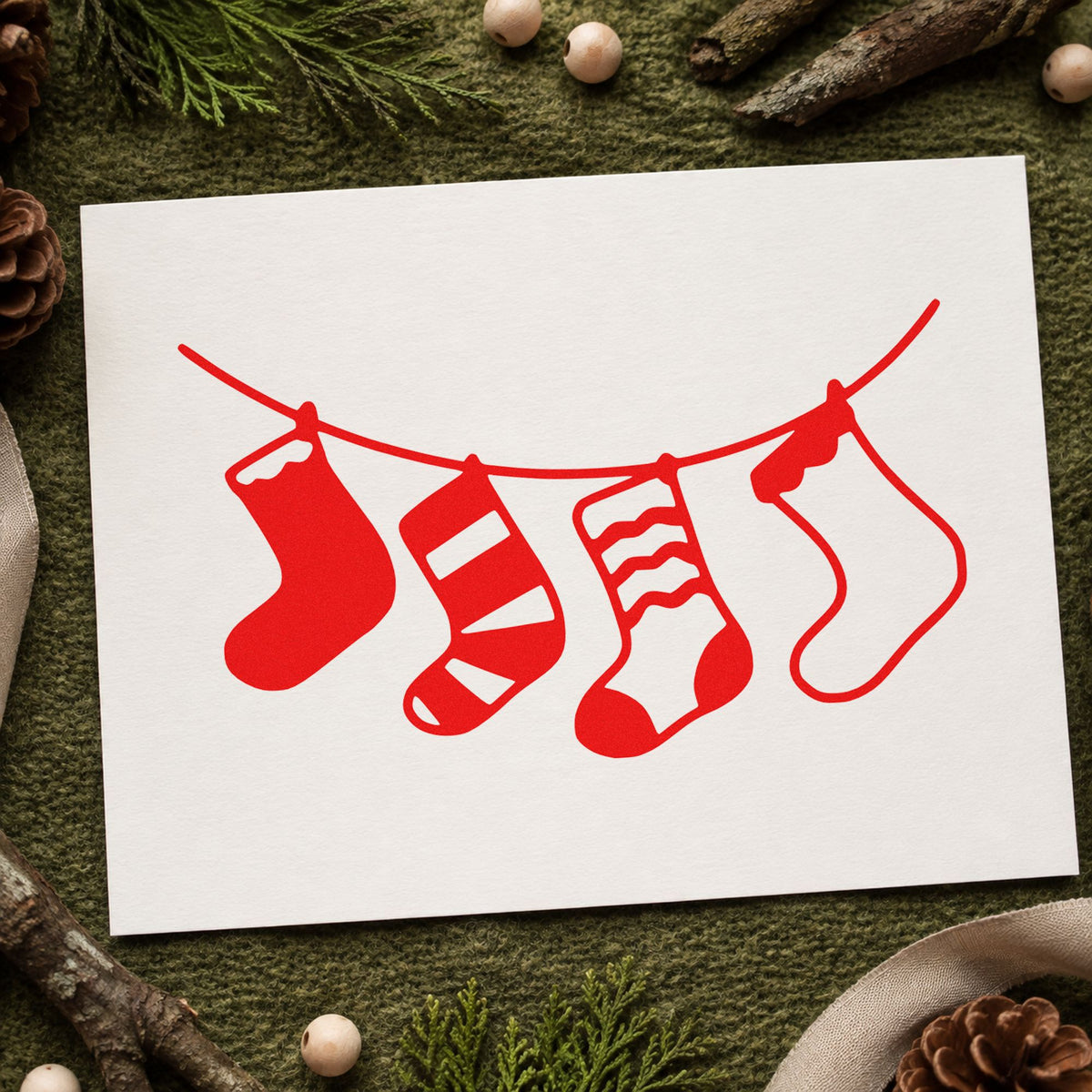 Four Hanging Christmas Stockings craft stamp in red ink on cardstock, an easy option for cord banner printing.