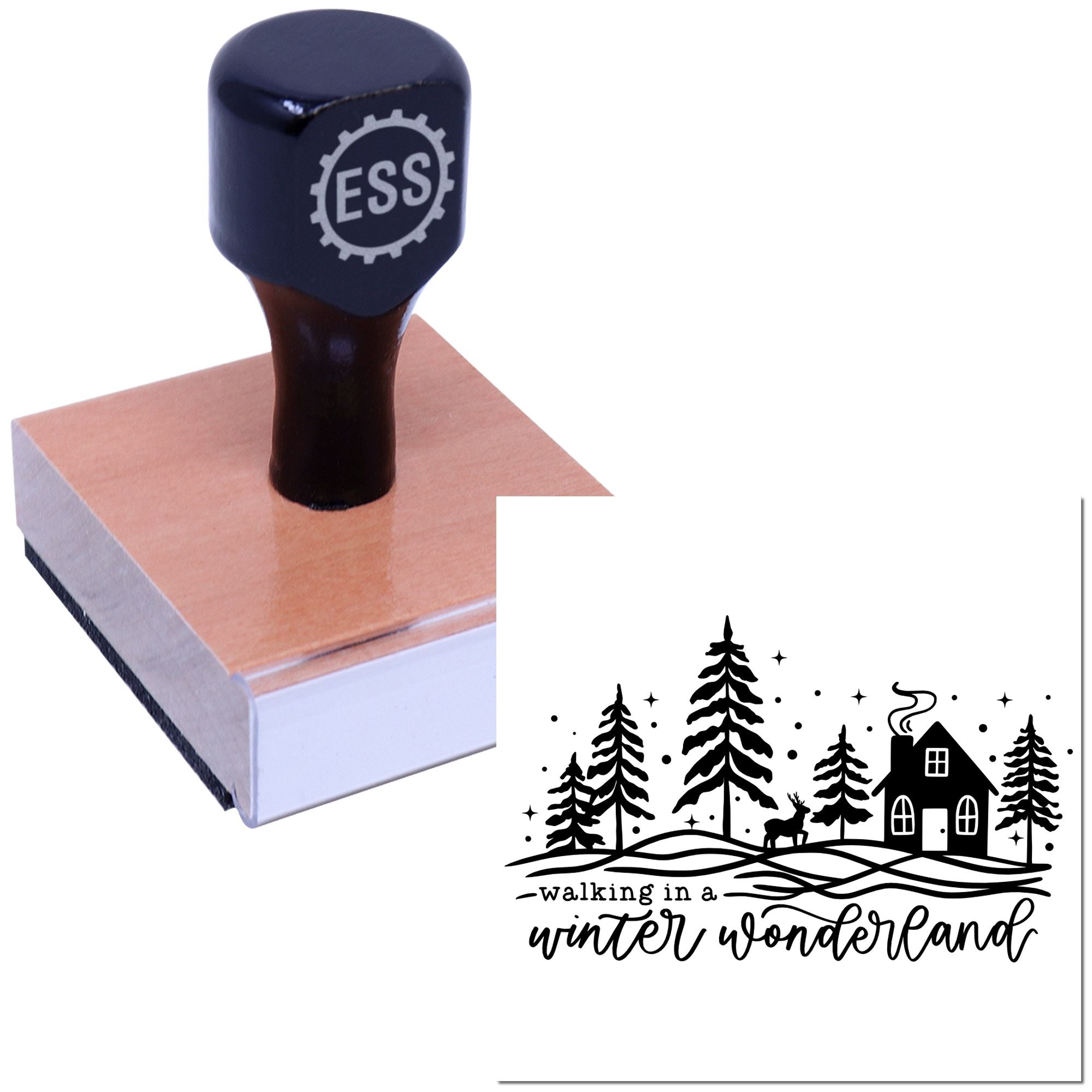 Dark blue ESS stamp and seal on a wooden block, showing a black winter wonderland design with trees, cabin and deer.
