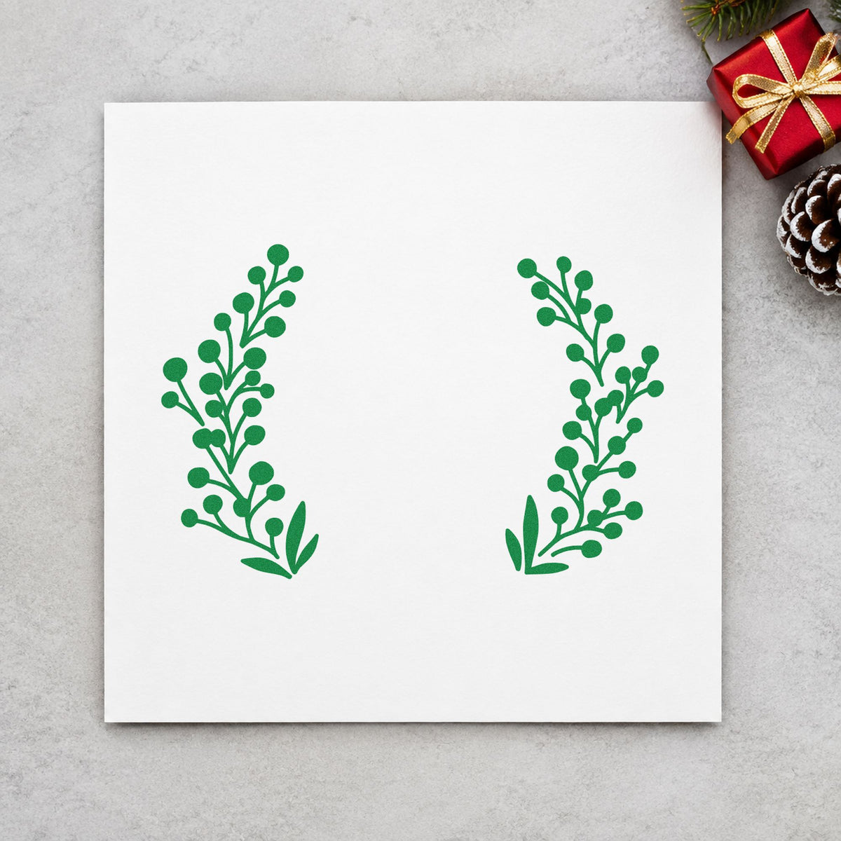 Open Berry Branch Wreath craft stamp imprint in green ink on a handmade project, one idea being product price tags.
