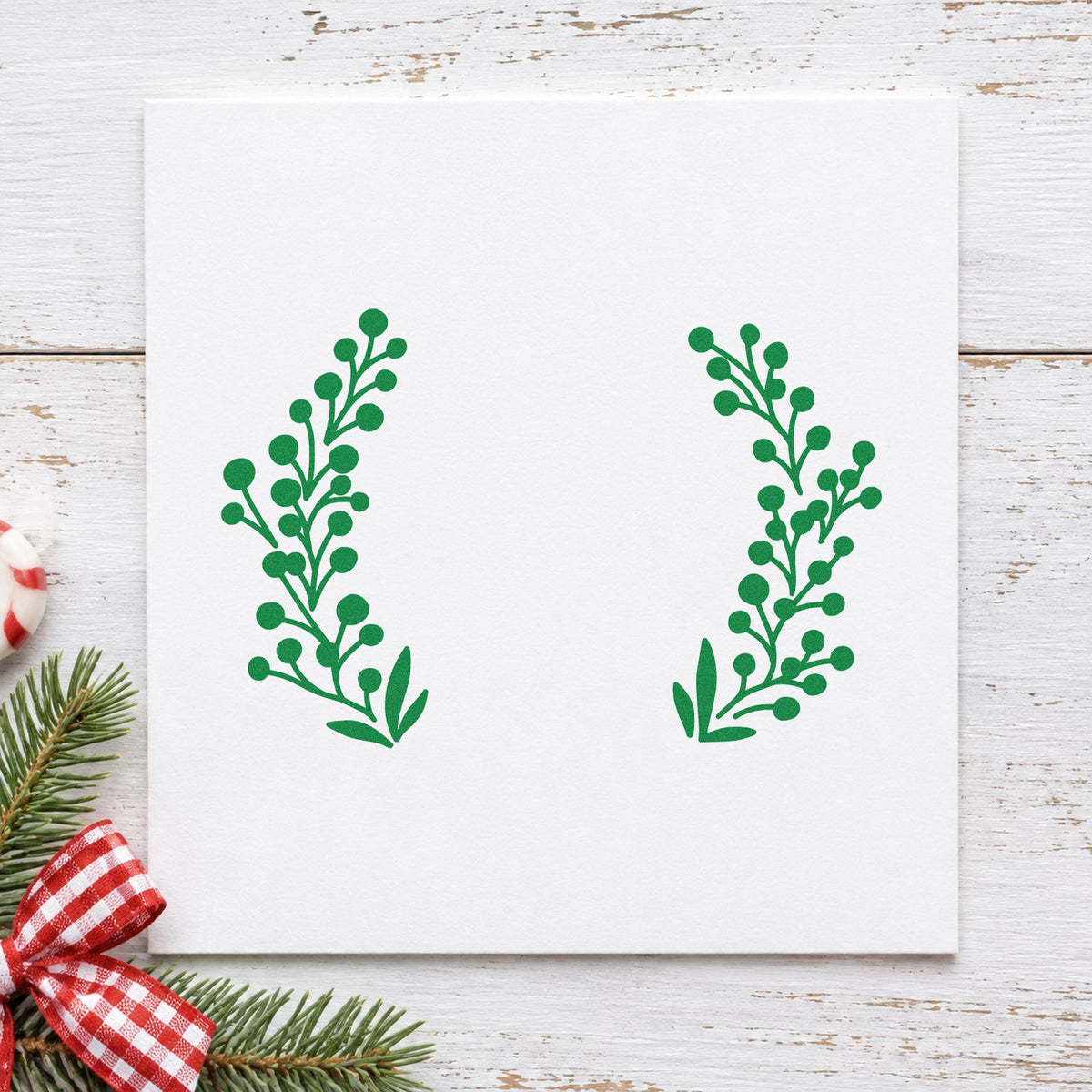 Open Berry Branch Wreath craft stamp imprinted in green ink on paper, a design suited to framed initial piece.