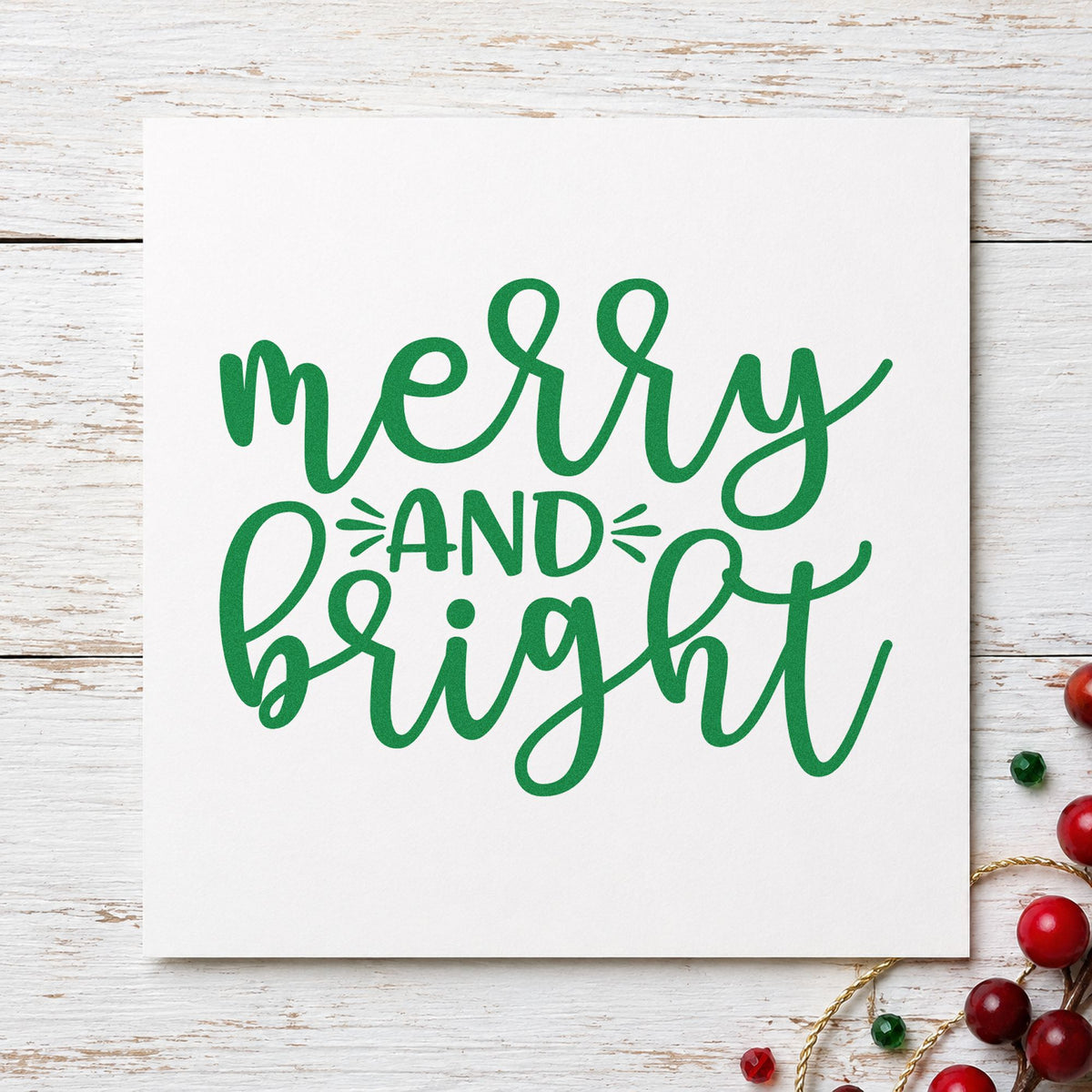 Merry And Bright Script craft stamp imprint in green ink on a handmade project, one idea being wrap station tags.