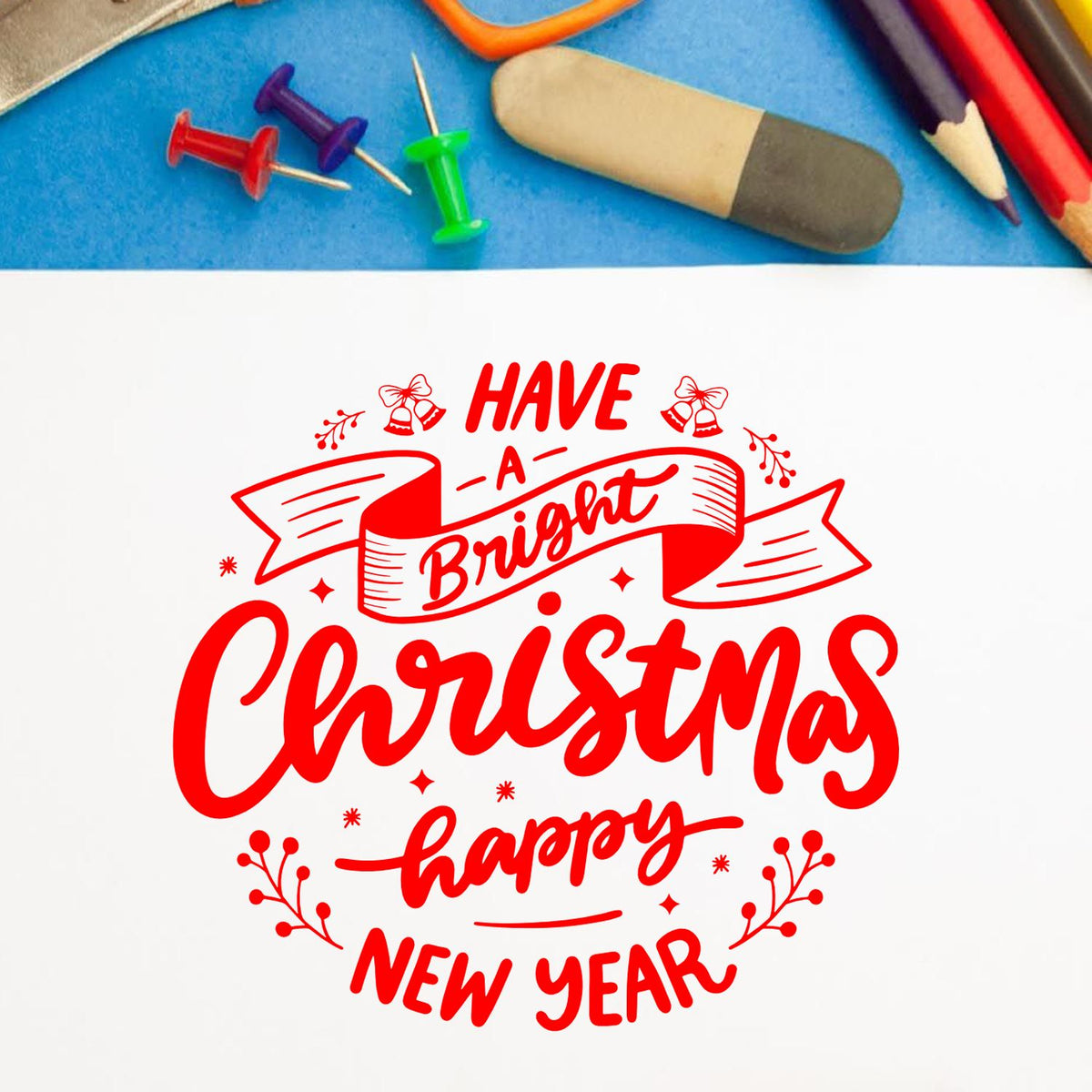 Red Christmas stamp and seal design with ribbon, bells, and festive accents reading Have a Bright Christmas Happy New Year.