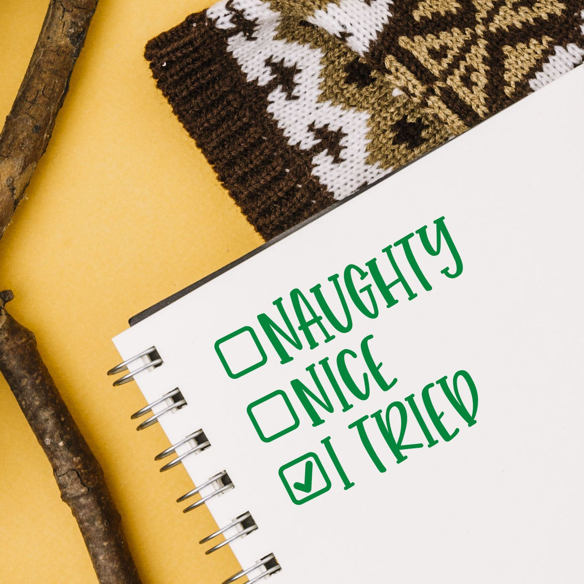 Green Naughty, Nice, I Tried stamp/seal on white spiral notebook with checked box, yellow background and rustic accents.