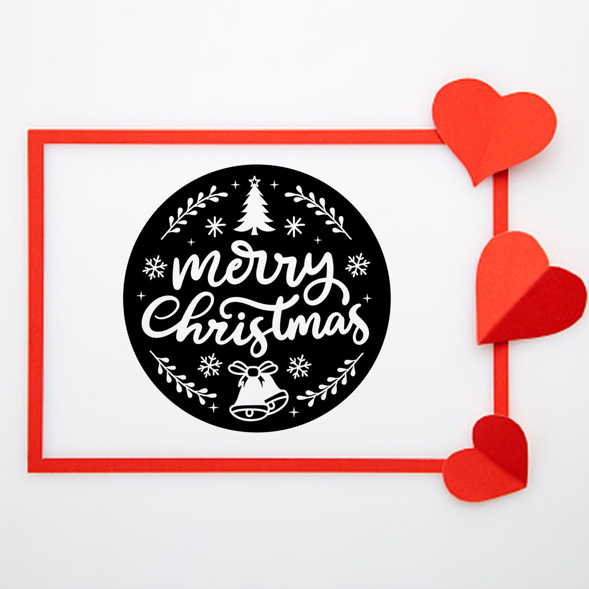 Black Merry Christmas stamp seal with white lettering, snowflakes and bells, framed in red with red heart decorations.