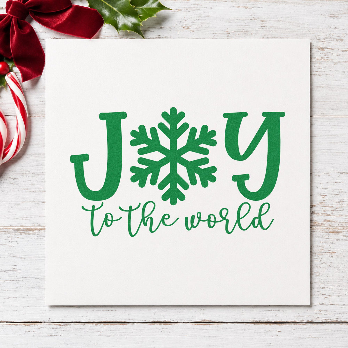 Joy World Snowflake Letter craft stamp imprint in green ink on a handmade project, one idea being flake craft gift tags.