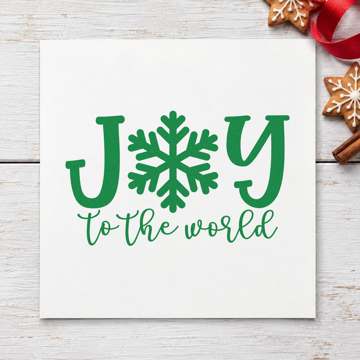 Joy World Snowflake Letter craft stamp imprint in green ink on a handmade project, one idea being craft class passes.