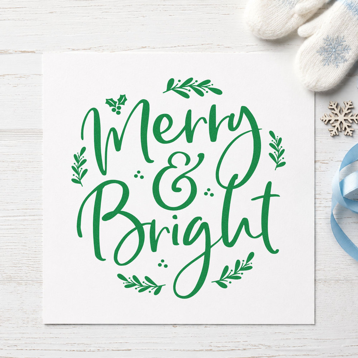 Merry And Bright Botanical craft stamp imprint in green ink on a handmade project, one idea being coordinated gift tags.