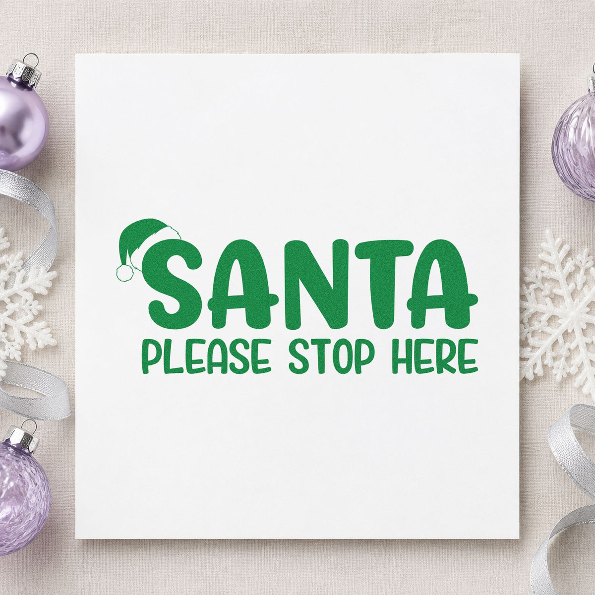 Santa Please Stop Here craft stamp imprint in green ink on a handmade project, one idea being bedroom door tags.