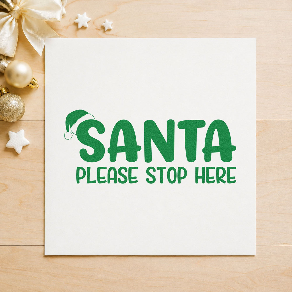 Santa Please Stop Here craft stamp imprinted in green ink on paper, a design suited to framed window sign.