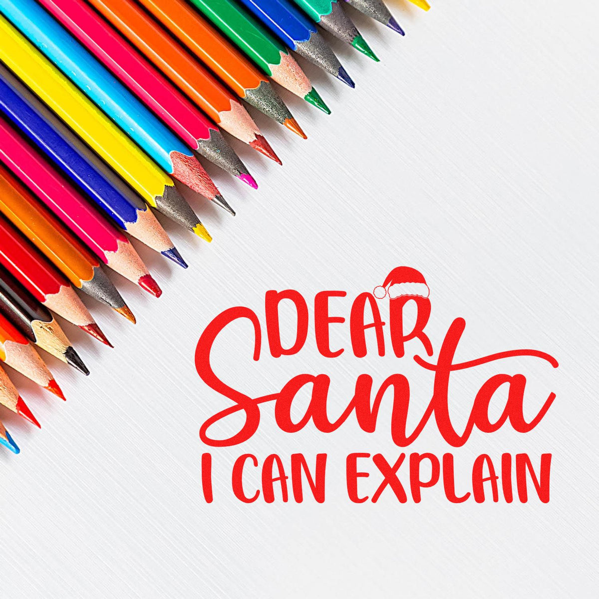 Red Dear Santa I Can Explain stamp/seal design with Santa hat, surrounded by colorful pencils on a white background.