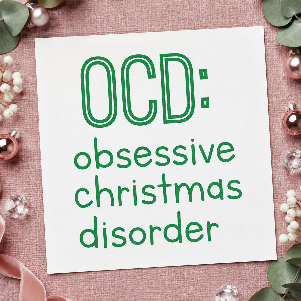 Obsessive Christmas Disorder craft stamp imprint in green ink on a handmade project, one idea being tour ticket placards.