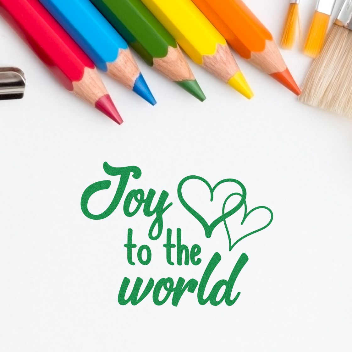 Joy To World Hearts rubber stamp shown in green ink, stamped for projects such as service album page.