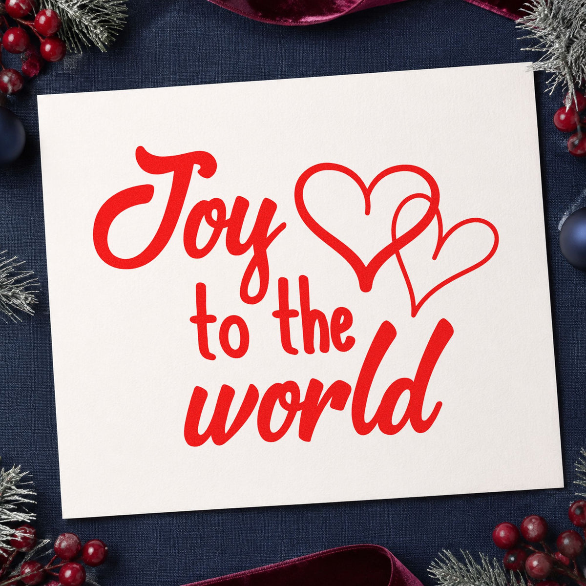 Joy To World Hearts craft stamp in red ink on cardstock, an easy option for blanket drive ink.