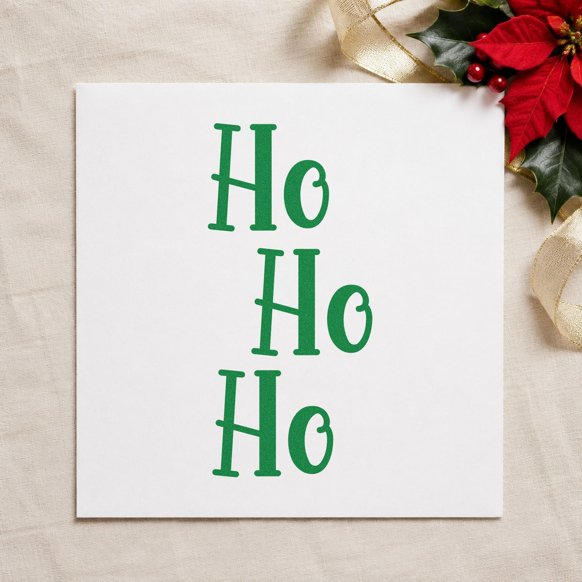 Three Stacked Ho Words craft stamp imprint in green ink on a handmade project, one idea being shop door placards.