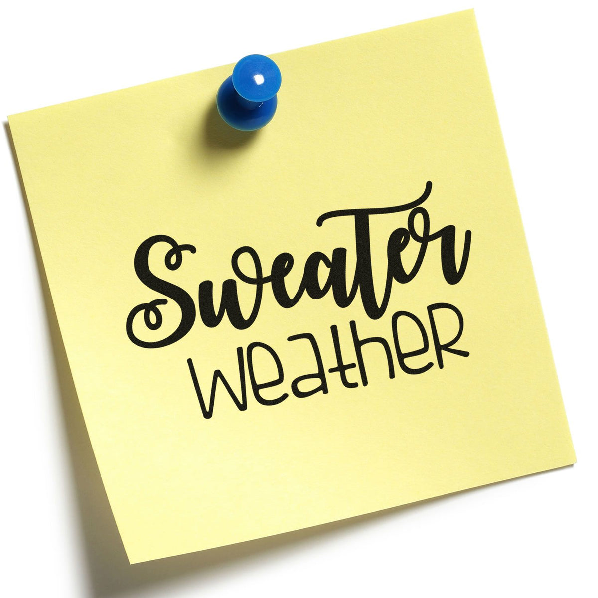 Yellow sticky note with black Sweater Weather stamp seal, pinned by a blue pushpin.