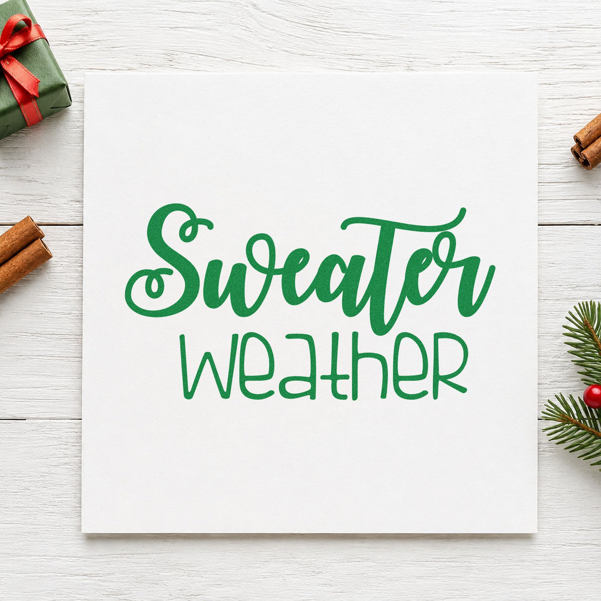 Sweater Weather Script craft stamp imprinted in green ink on paper, a design suited to framed craft nook.