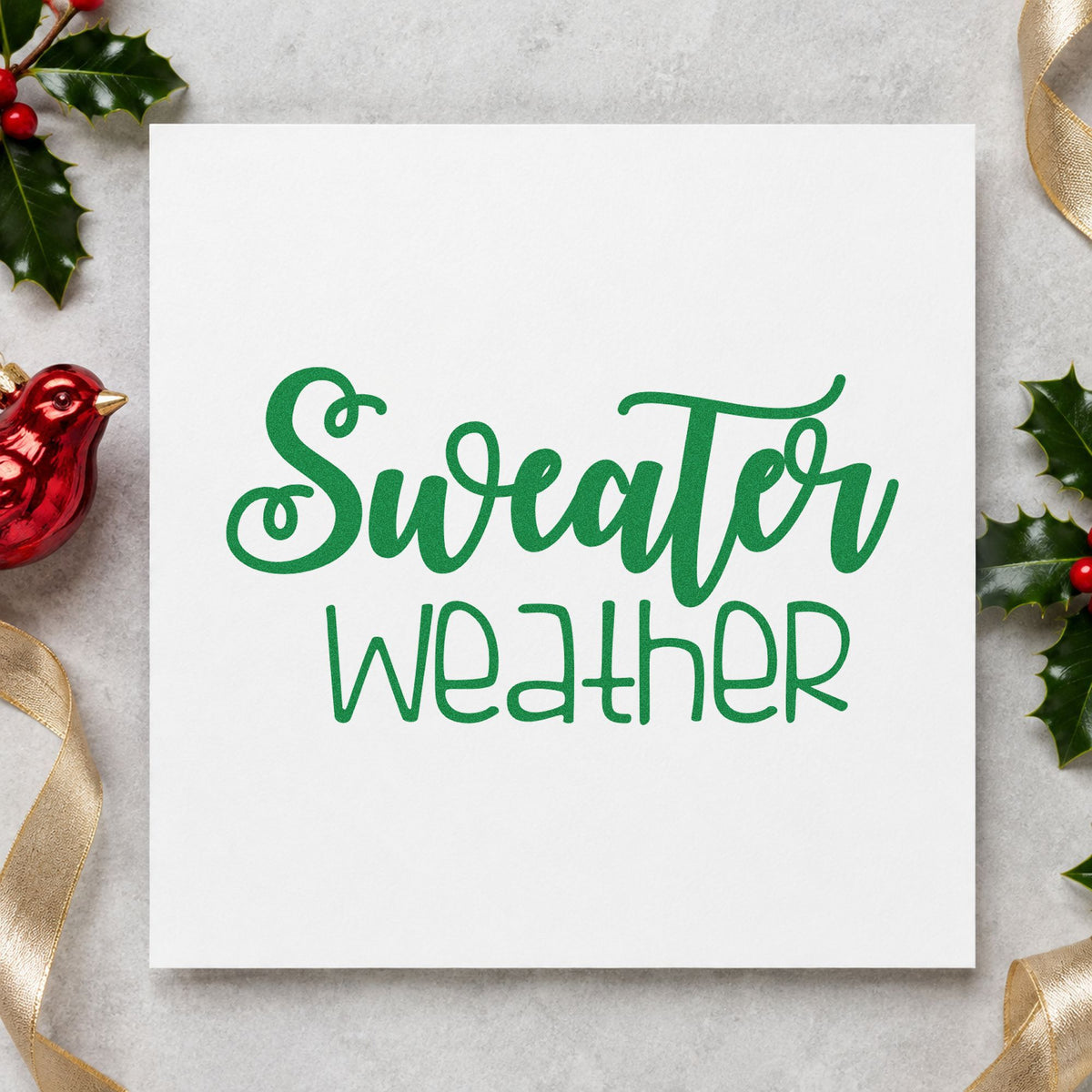 Sweater Weather Script craft stamp imprint in green ink on a handmade project, one idea being knit night invites.