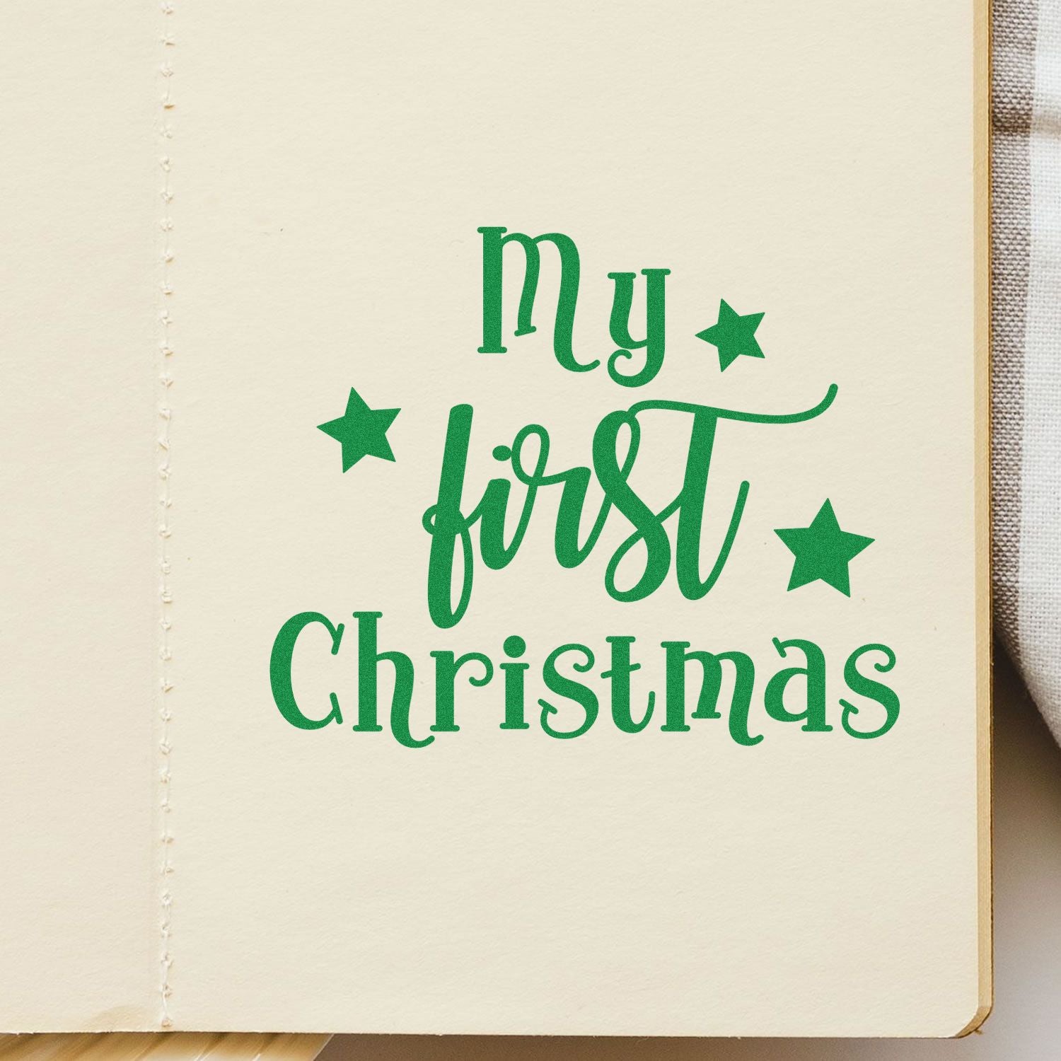 Green My first Christmas stamp and seal with stars on cream paper for a festive keepsake.
