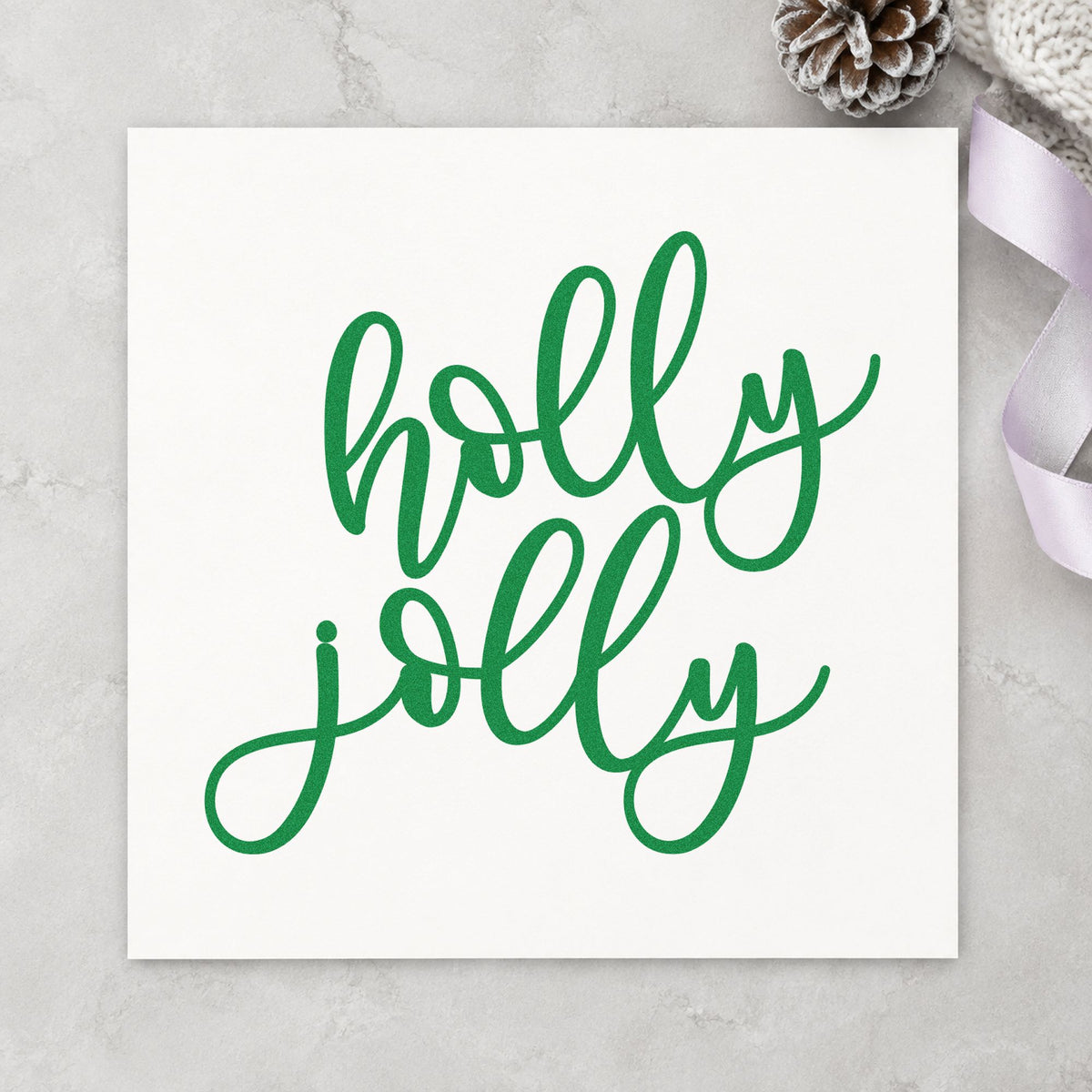 Holly Jolly Script craft stamp imprint in green ink on a handmade project, one idea being two word gift tags.