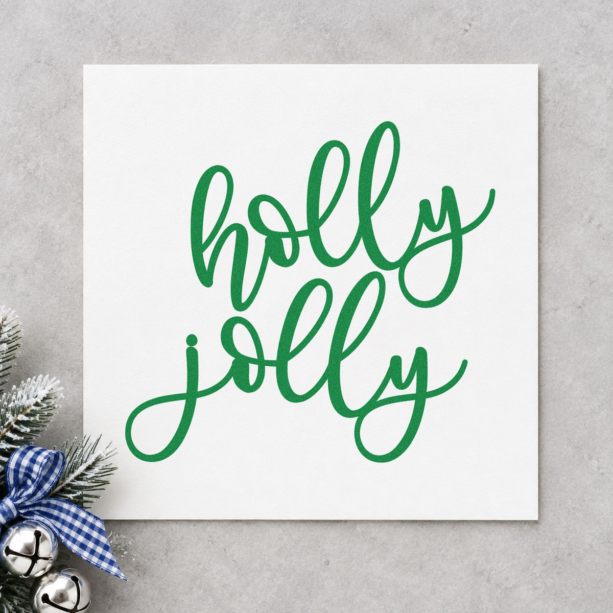 Holly Jolly Script craft stamp imprint in green ink on a handmade project, one idea being booth sign boards.