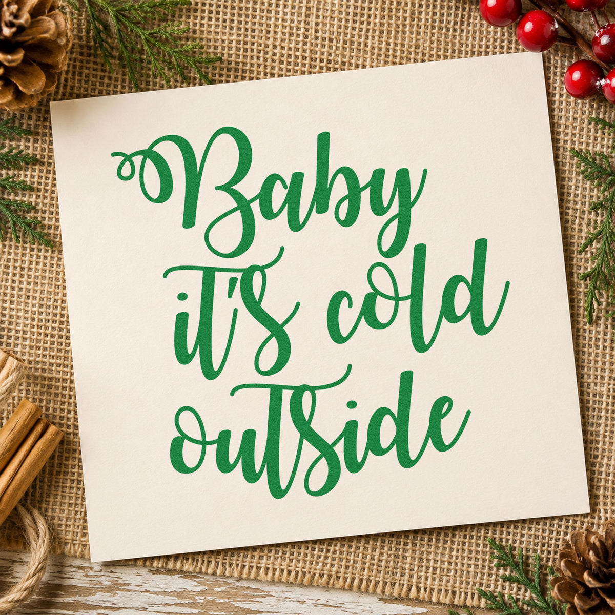 Baby It's Cold Outside Script craft stamp imprint in green ink on a handmade project, one idea being warming center signs.