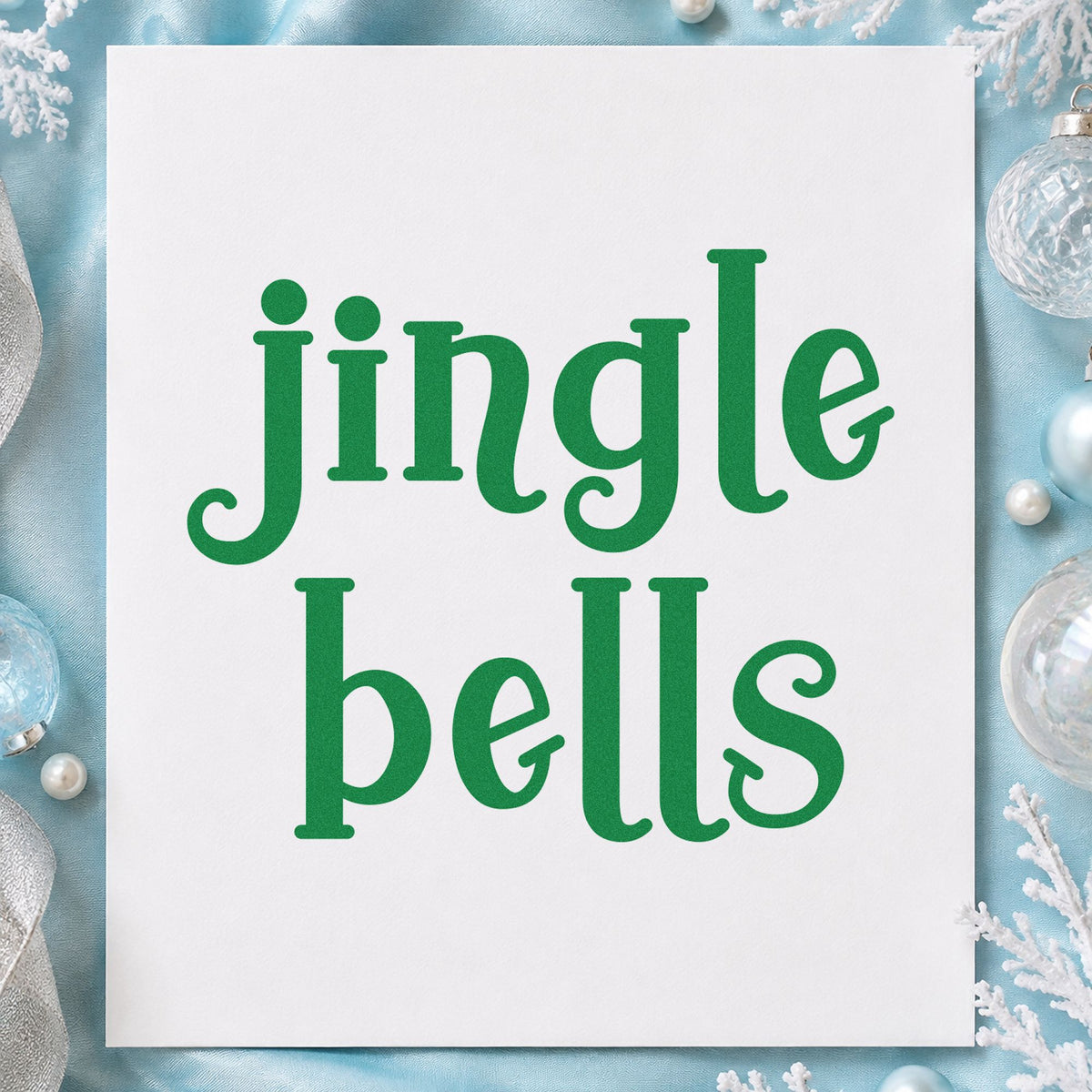 Jingle Bells Serif craft stamp imprint in green ink on a handmade project, one idea being bell case gift tags.