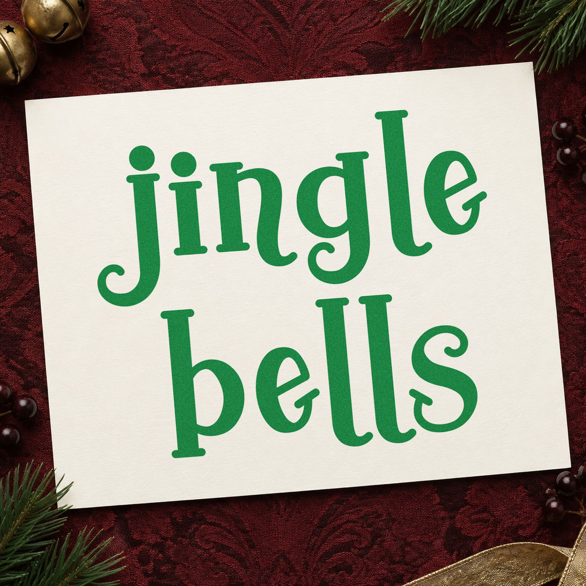 Jingle Bells Serif craft stamp imprint in green ink on a handmade project, one idea being ensemble concert cards.