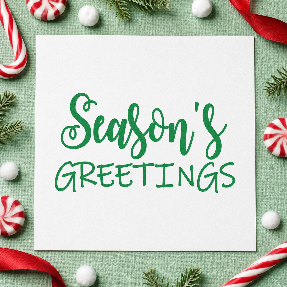 Season's Greetings Mixed Lettering craft stamp imprint in green ink on a handmade project, one idea being turndown gift tags.