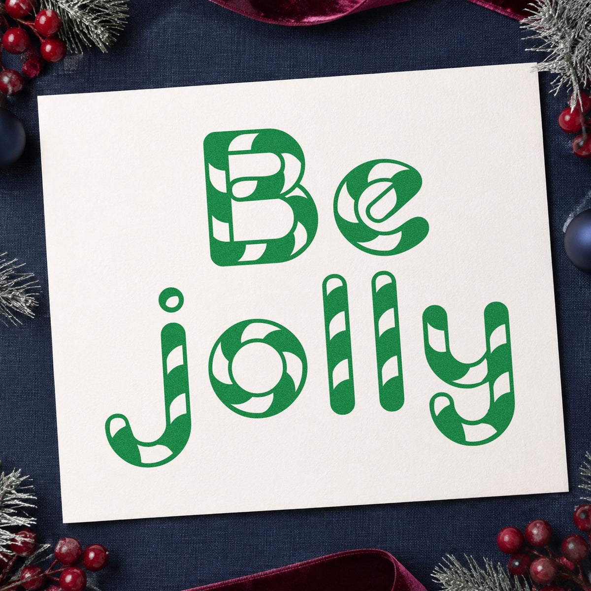 Be Jolly Patterned Letters craft stamp imprint in green ink on a handmade project, one idea being mint tin gift tags.