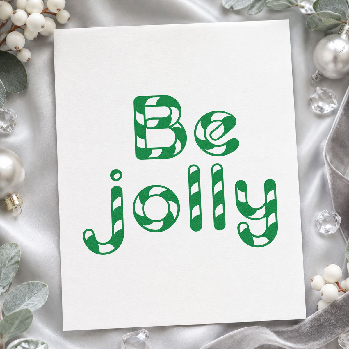 Be Jolly Patterned Letters craft stamp imprint in green ink on a handmade project, one idea being gift box inserts.