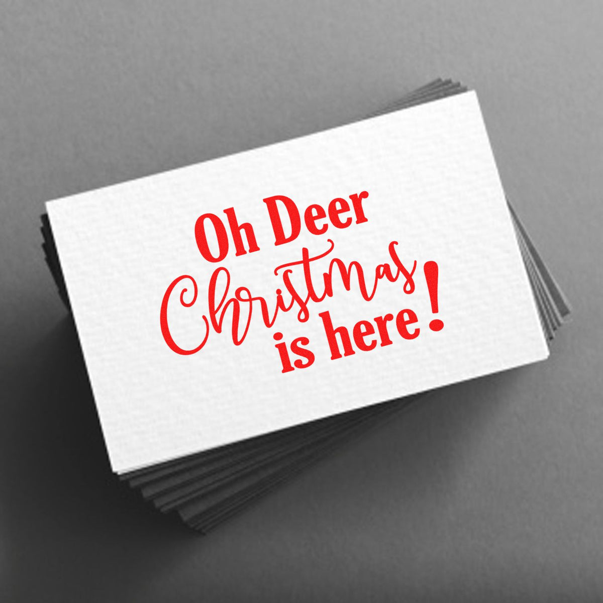 Red holiday stamp and seal design on white cards reading Oh Deer Christmas is here!