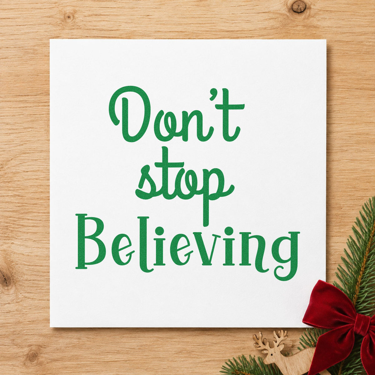Don't Stop Believing craft stamp imprint in green ink on a handmade project, one idea being encouragement tags.